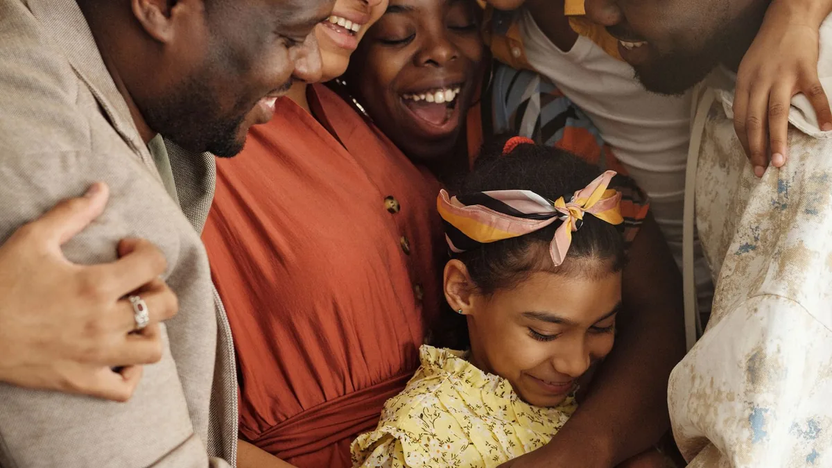 A family watching a film together in a warmly lit living room