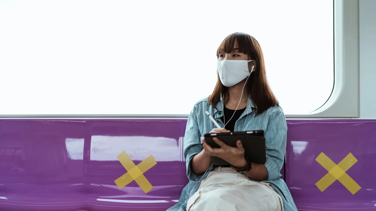 A commuter using a tablet on a train
