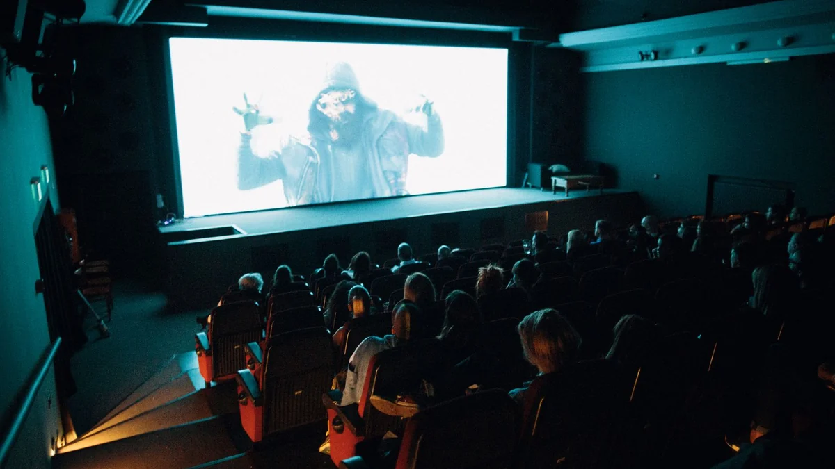 An audience watching a film on a large cinema screen