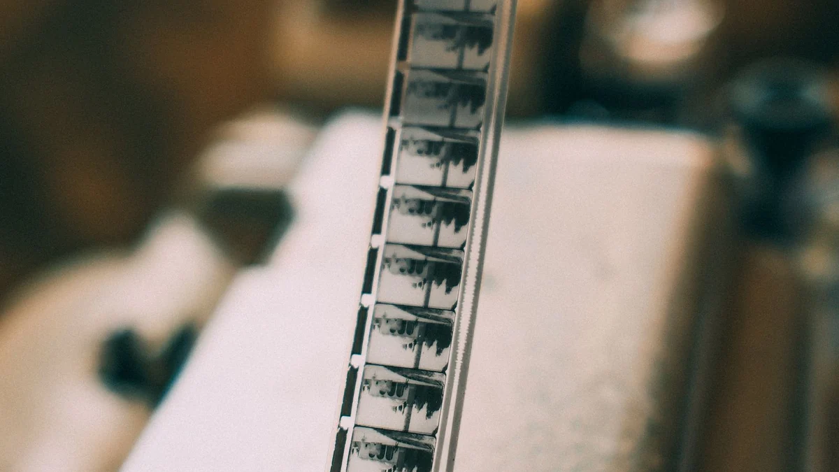 A close-up of a vintage film strip running through a projector