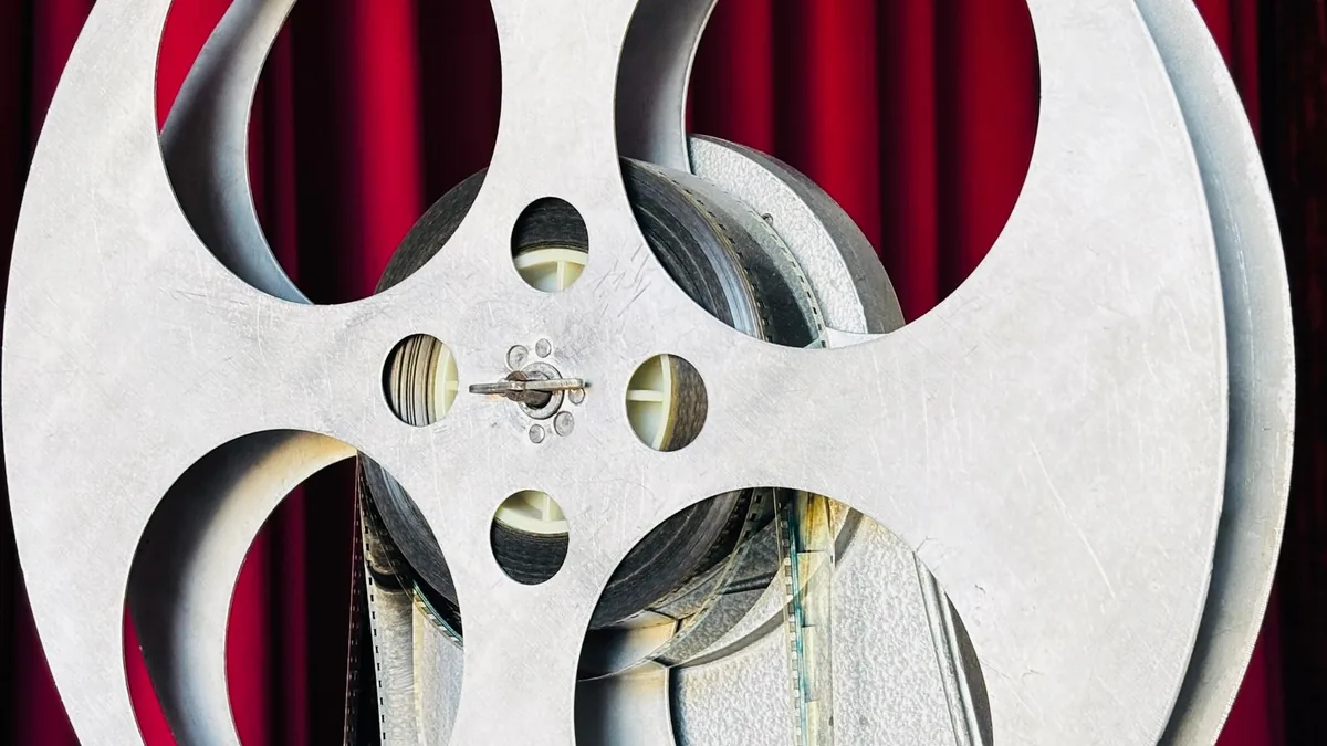A vintage film projector standing in a darkened room