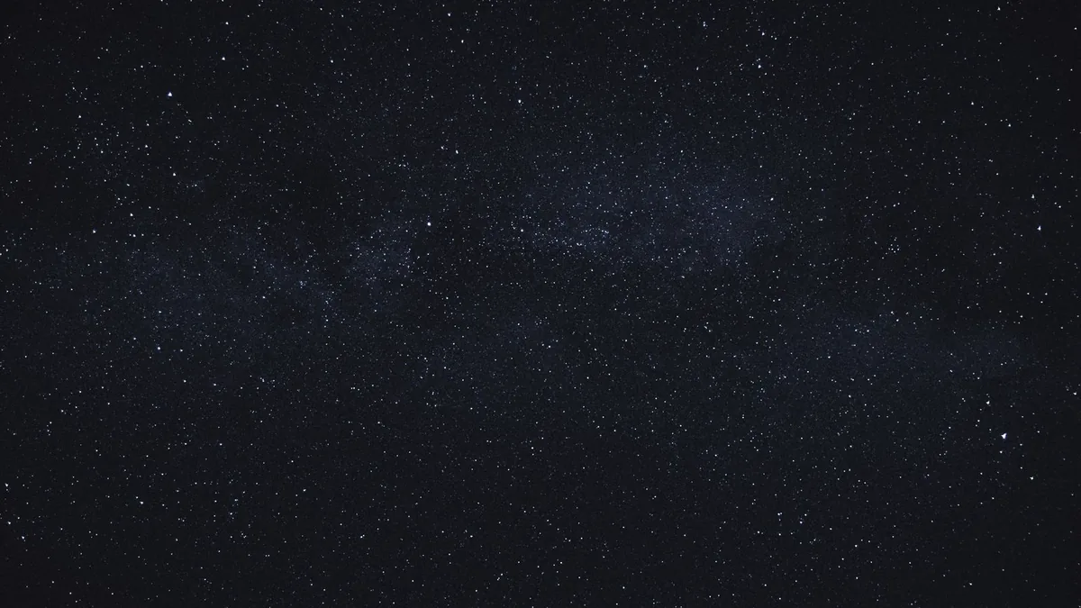 A dense cluster of stars in a dark night sky